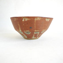 Ceramic bowl with brown and beige glaze on a white background