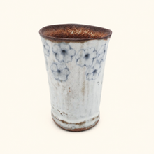 Spako Clay tumbler with blue floral patterns on a white background