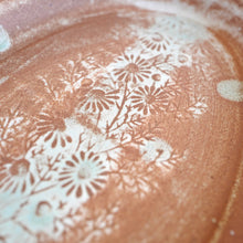 Floral patterns embossed on a textured surface