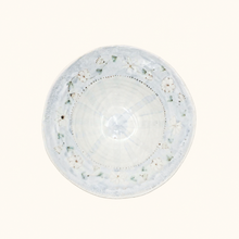 Round ceramic bowl with floral patterns on a white background
