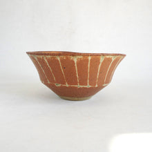 Ceramic bowl with a textured surface on a white background