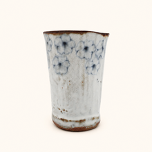 Spako Clay tumbler with blue floral patterns on a white background