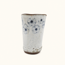 Spako Clay tumbler with blue floral patterns on a white background