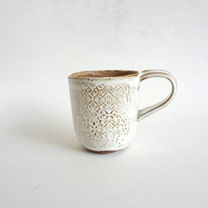 Spako Clay mug. Emboss pattern, white glaze