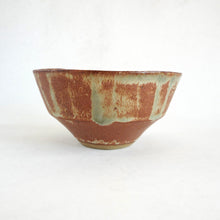 Ceramic bowl with a textured surface on a white background