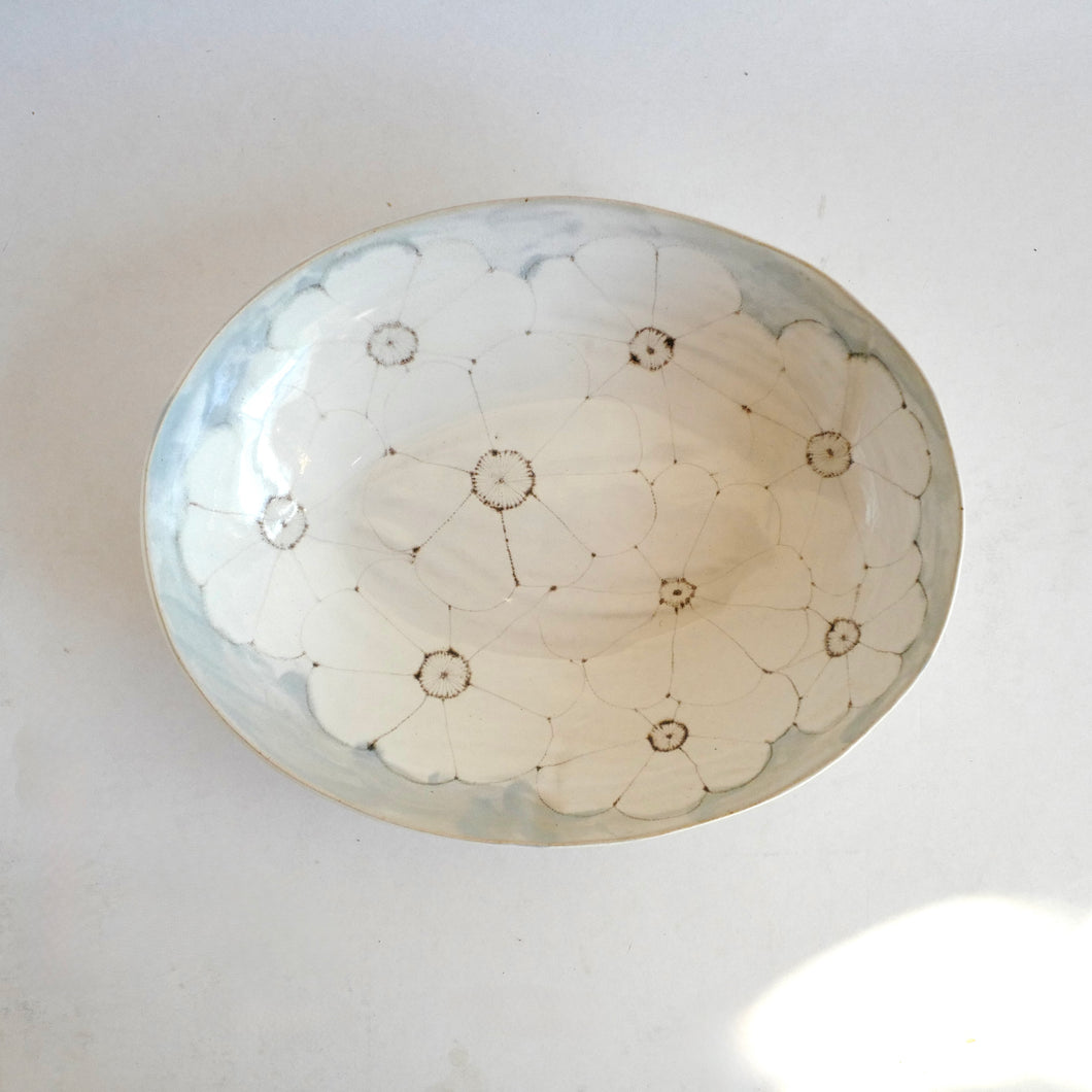 Round ceramic bowl with floral patterns on a white background