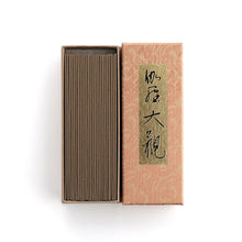 Traditional Japanese incense box and incense sticks with calligraphy on white background