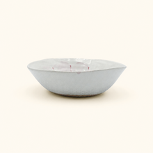 White ceramic bowl with subtle pattern on a white background