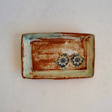 Rectangular ceramic dish with bird design on a white background