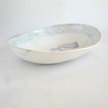 White ceramic bowl with pattern on a light gray background