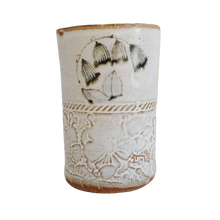 Ceramic vase with decorative patterns on a white background