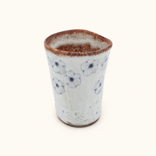 Spako Clay tumbler with blue floral patterns on a white background