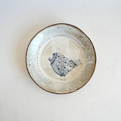 Ceramic plate with decorative edge on a white background