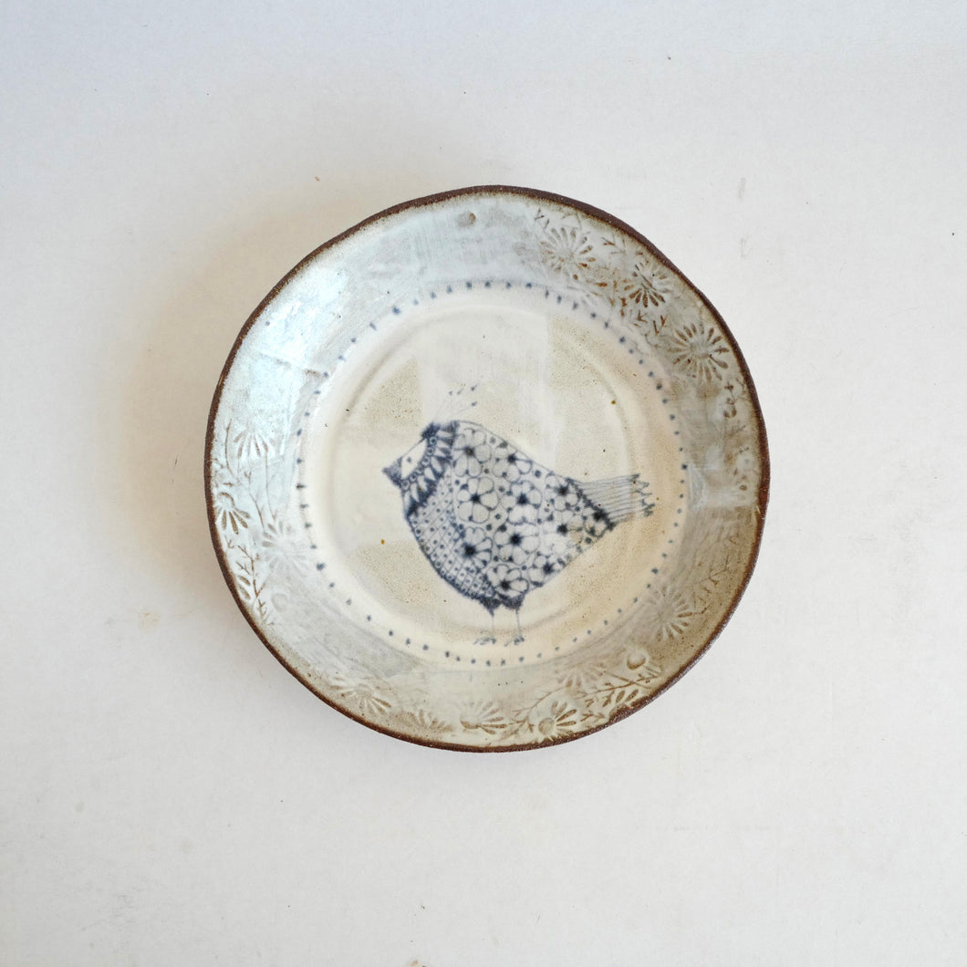 Ceramic plate with decorative edge on a white background