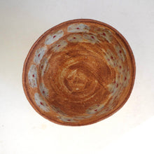 Ceramic bowl with red flora pattern on a white background
