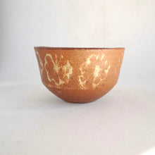 Ceramic bowl with a textured surface on a white background