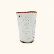 Spako Clay tumbler with blue floral patterns on a white background