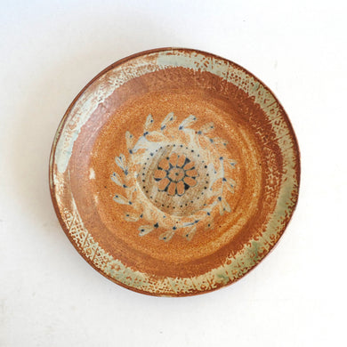 Ceramic plate with decorative design on a white background