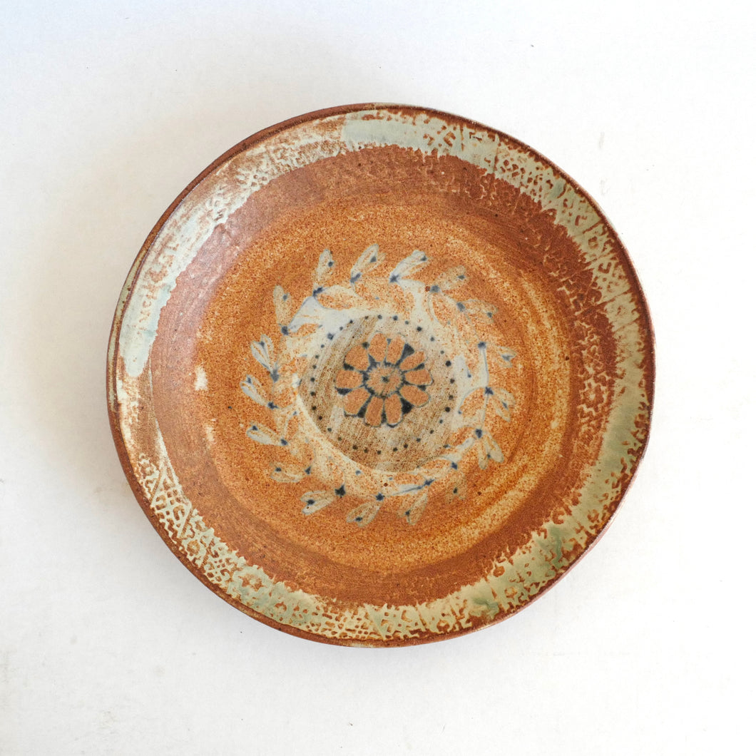 Ceramic plate with decorative design on a white background