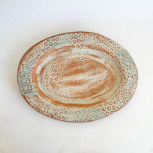 Ceramic plate with textured surface on a white background
