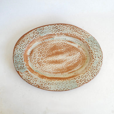 Ceramic plate with textured surface on a white background