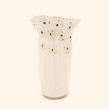 White ceramic vase with flower pattern on a white background