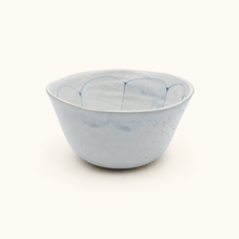 Ceramic bowl with blue abstract patterns on a white background