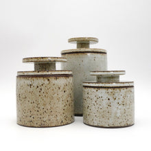 Set of MH Ceramic Studio ceramic jars with speckled glaze on a white background
