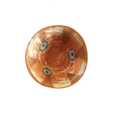 Ceramic bowl with brown glaze and blue drawing on a white background