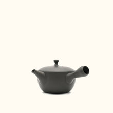 Black ceramic teapot on a white background
