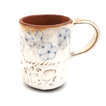 Ceramic mug with floral patterns on a white background