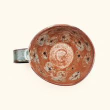 Ceramic cup with floral patterns on a white background