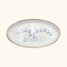 Ceramic tray with blue floral patterns on a white background