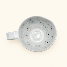 Spako Clay cappuccino mug with floral patterns on a white background