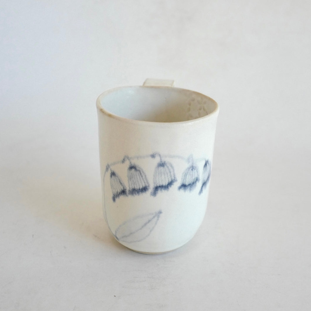Mug with blue flower pattern on beige background