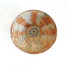 Ceramic bowl with decorative patterns on a white background
