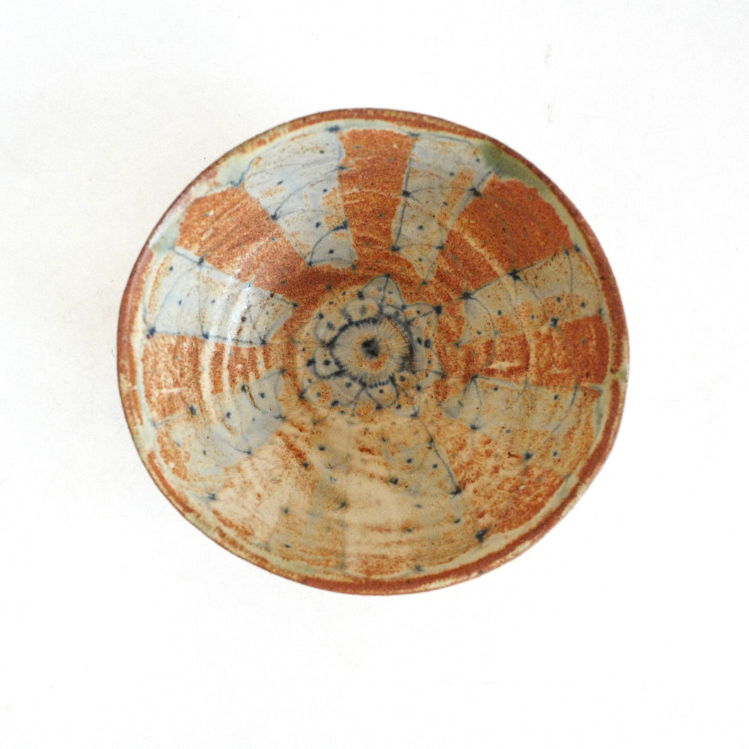 Ceramic bowl with decorative patterns on a white background