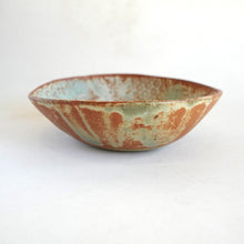 Ceramic bowl with a textured surface on a white background
