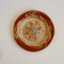 Ceramic plate with floral design on a white background