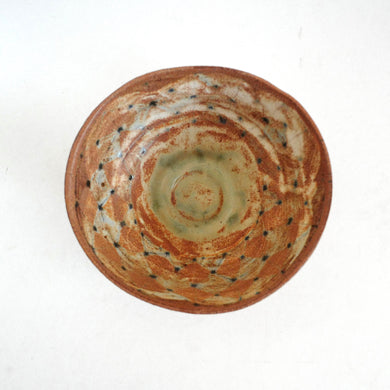 Ceramic bowl with a unique pattern on a white background