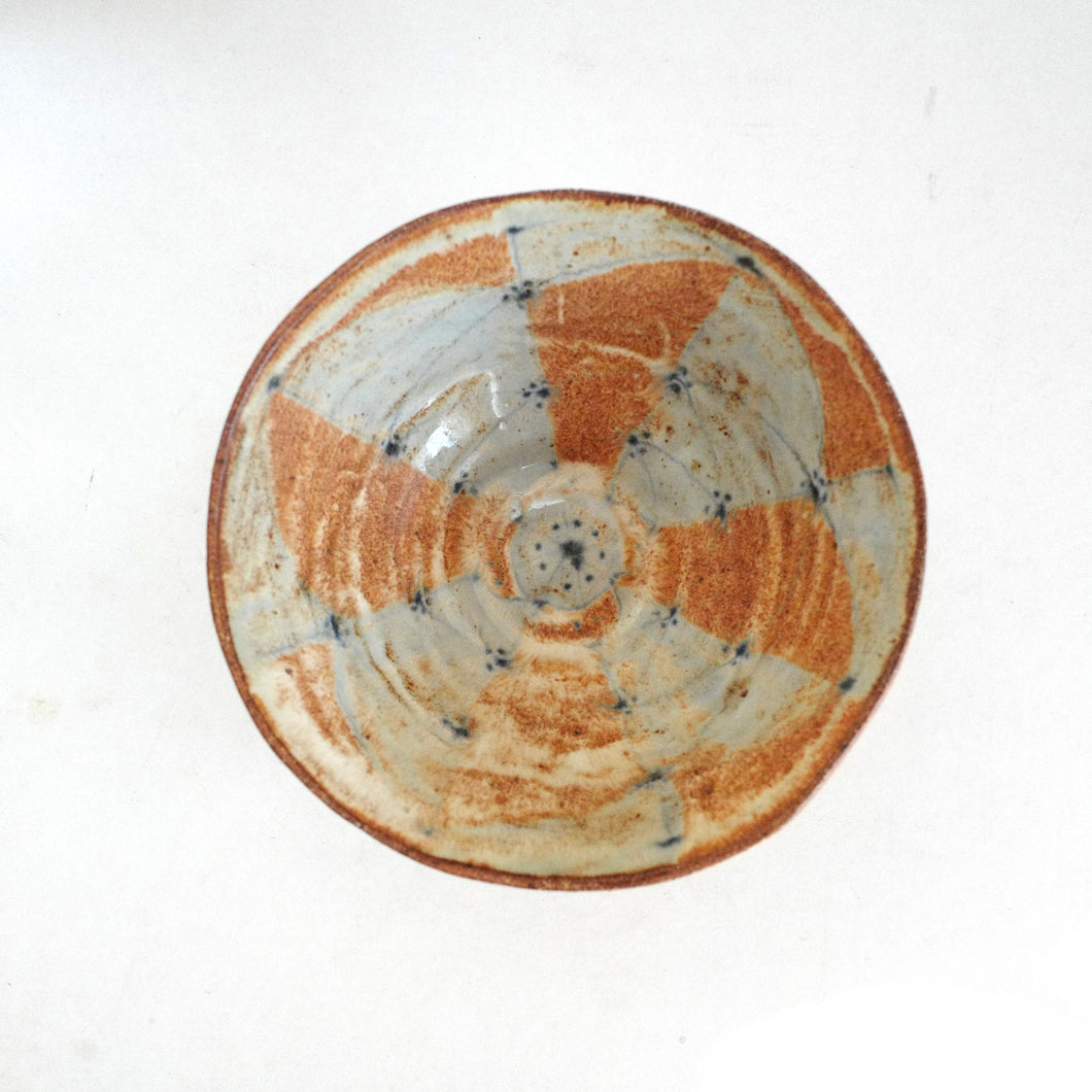 Ceramic bowl with a unique pattern on a white background