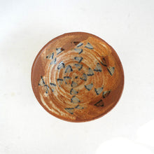 Ceramic bowl with floral designs on a white background