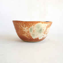 Ceramic bowl with textured surface on a white background