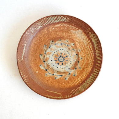 Ceramic plate with decorative patterns on a white background