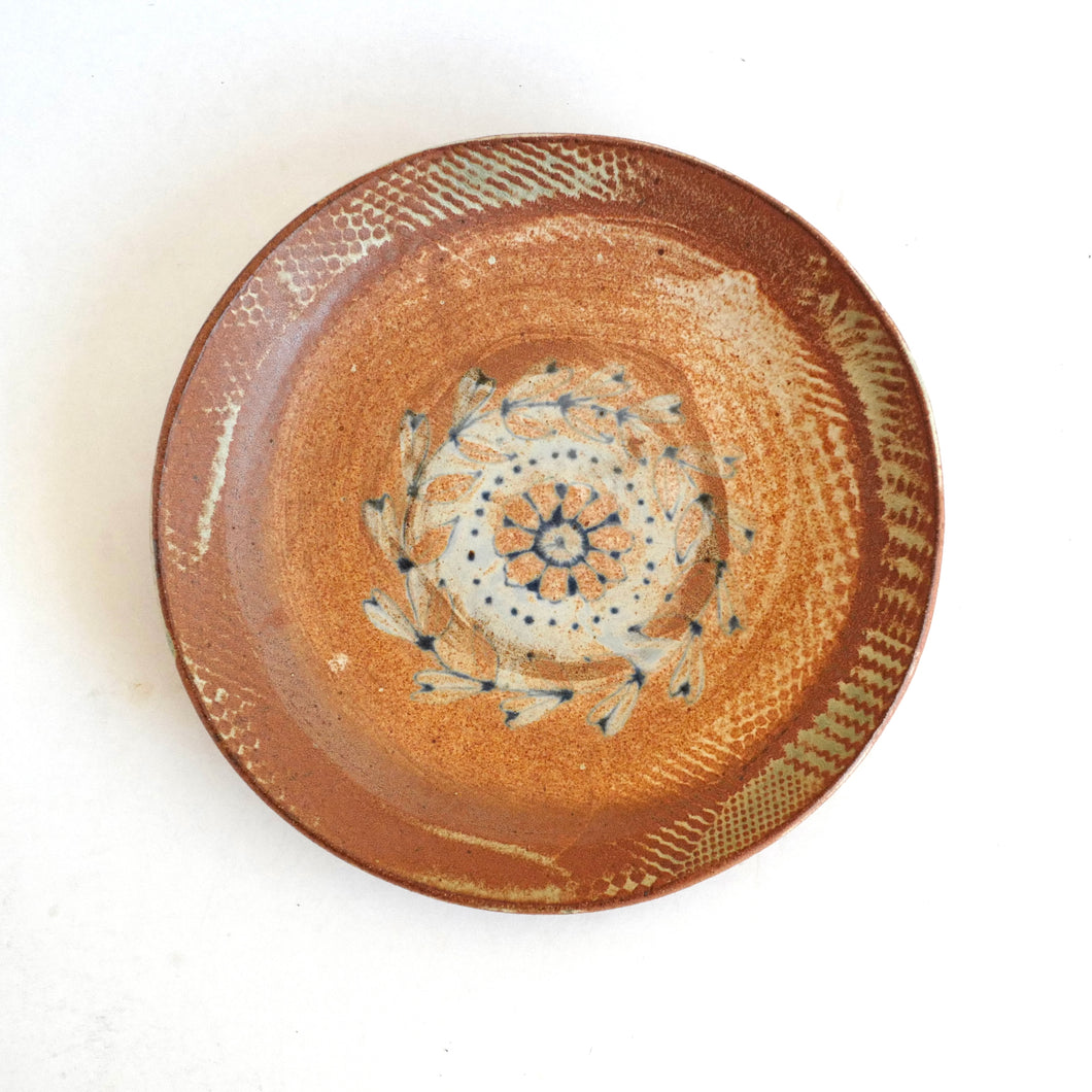 Ceramic plate with decorative patterns on a white background