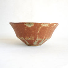 Ceramic bowl with a textured surface on a white background