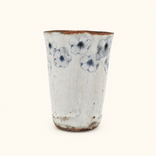 Spako Clay tumbler with blue floral patterns on a white background