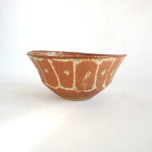 Ceramic bowl with a textured surface on a white background