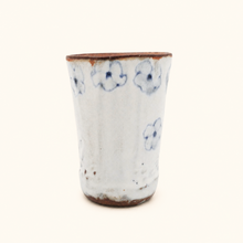 Spako Clay tumbler with blue floral patterns on a white background