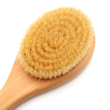 Wooden scrub brush with natural bristles on a white background